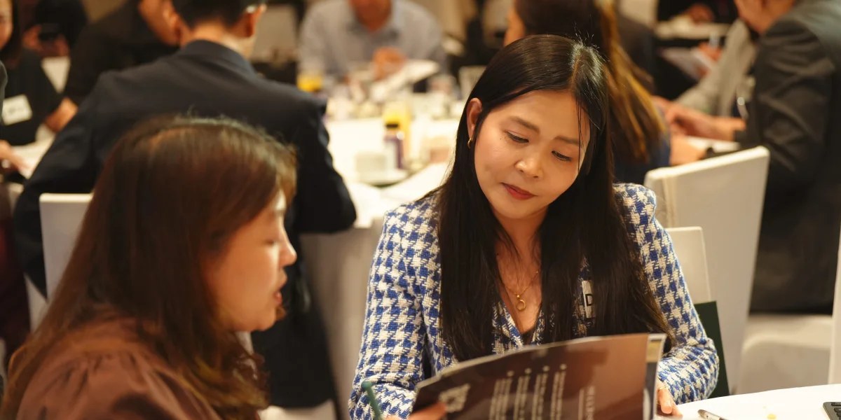 Two participants reading programme materials